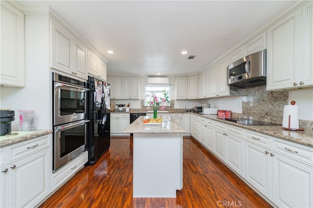 1855 Turnbull Canyon Rd, Hacienda Heights, CA 91745 - kitchen with black appliances, white cabinets, a kitchen island, dark wood-style floors, and recessed lighting