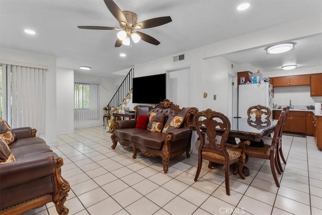 12912 Lariat Ln, Norwalk, CA 90650 - living area featuring light tile patterned floors, ceiling fan, stairs, and recessed lighting