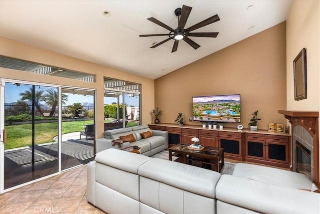 32091 Camino Nunez, Temecula, CA 92592 - living room with ceiling fan, a glass covered fireplace, light tile patterned floors, and high vaulted ceiling