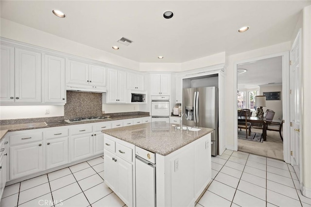 1526 S 2nd Ave, Arcadia, CA 91006 - kitchen with white appliances, a center island with sink, light tile patterned floors, white cabinetry, and recessed lighting