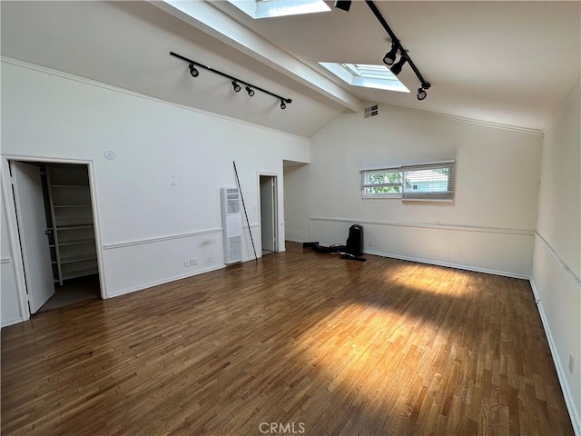 14655 Morrison St, Sherman Oaks, CA 91403 - empty room featuring rail lighting, a skylight, a heating unit, wood finished floors, and lofted ceiling