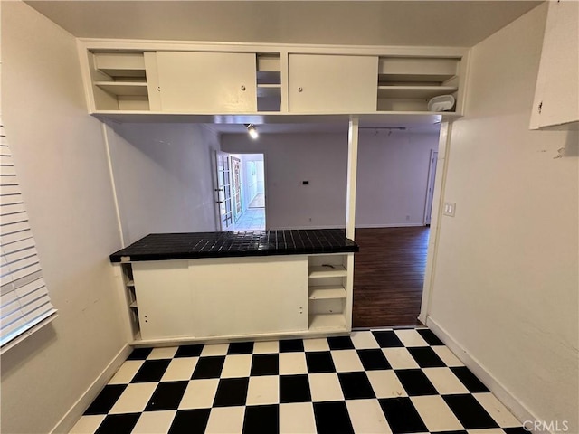14655 Morrison St, Sherman Oaks, CA 91403 - kitchen with open shelves, tile patterned floors, white cabinets, and dark countertops