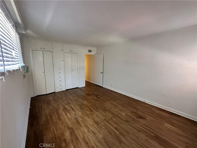 14655 Morrison St, Sherman Oaks, CA 91403 - unfurnished bedroom featuring dark wood-style flooring and baseboards