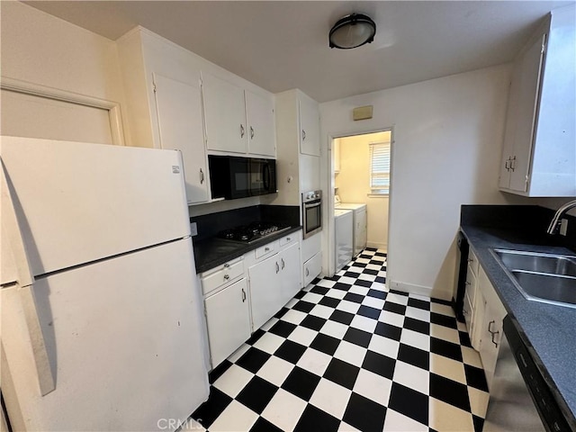 14655 Morrison St, Sherman Oaks, CA 91403 - kitchen with appliances with stainless steel finishes, separate washer and dryer, tile patterned floors, dark countertops, and white cabinetry