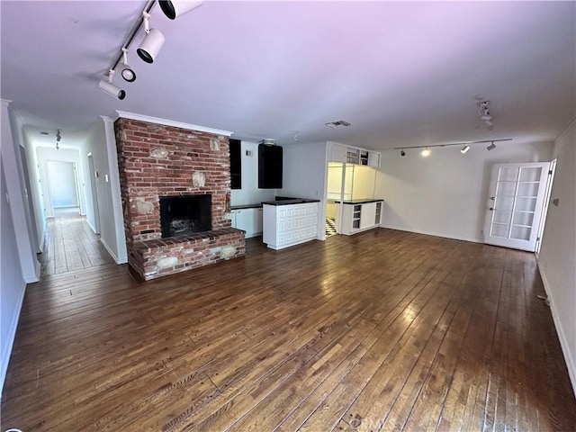 14655 Morrison St, Sherman Oaks, CA 91403 - unfurnished living room with track lighting, wood-type flooring, and a brick fireplace