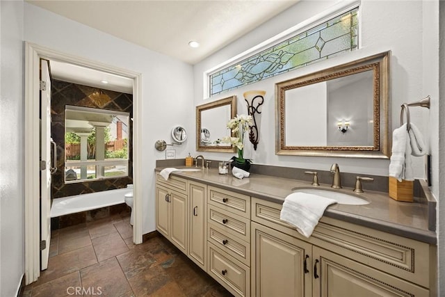 925 Calle Hermosa, San Dimas, CA 91773 - bathroom with double vanity, stone tile floors, and a tub