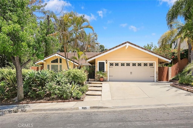 925 Calle Hermosa, San Dimas, CA 91773 - view of front of home with an attached garage, driveway, a tiled roof, and stone siding