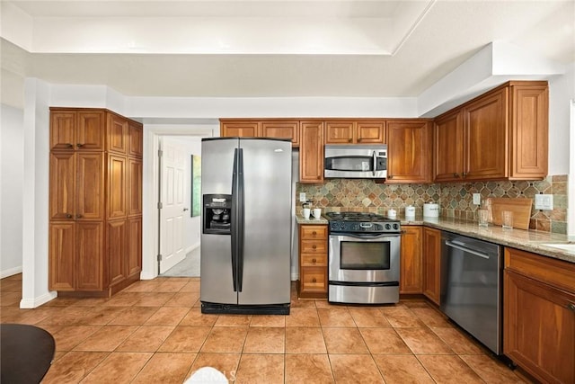 925 Calle Hermosa, San Dimas, CA 91773 - kitchen featuring stainless steel appliances, brown cabinets, and backsplash