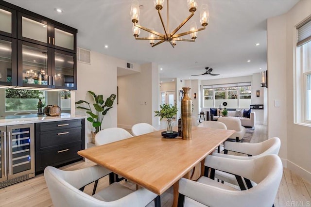 3285 5th Ave, San Diego, CA 92103 - dining area with beverage cooler, light wood-style flooring, a chandelier, wet bar, and recessed lighting