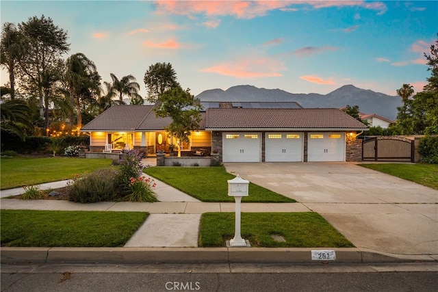 251 Miramar St, Upland, CA 91784 - view of front of property featuring a tile roof, a gate, a garage, concrete driveway, and a lawn