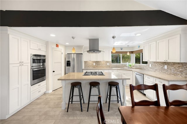 251 Miramar St, Upland, CA 91784 - kitchen featuring stainless steel appliances, island exhaust hood, a kitchen bar, decorative backsplash, and white cabinetry