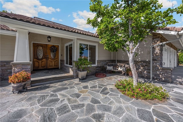251 Miramar St, Upland, CA 91784 - property entrance with stone siding and a tile roof