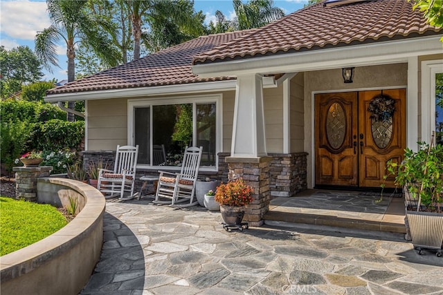 251 Miramar St, Upland, CA 91784 - doorway to property featuring a tile roof and stone siding