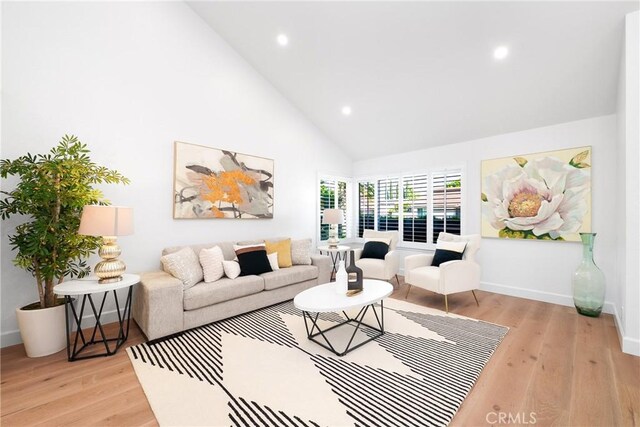 27591 Cenajo, Mission Viejo, CA 92691 - living room featuring light wood-type flooring, high vaulted ceiling, recessed lighting, and baseboards
