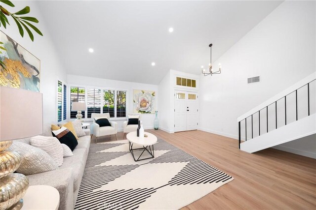 27591 Cenajo, Mission Viejo, CA 92691 - living area featuring high vaulted ceiling, stairway, wood finished floors, a chandelier, and recessed lighting