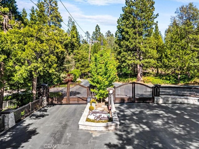 27833 Hamiltair Dr, Lake Arrowhead, CA 92352 - view of asphalt street featuring a gate, a gated entry, and view of scattered trees