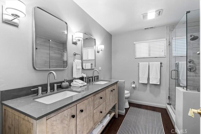 27833 Hamiltair Dr, Lake Arrowhead, CA 92352 - bathroom with double vanity, wood finished floors, a stall shower, toilet, and baseboards