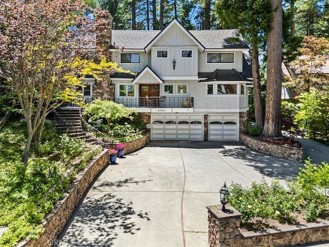 27833 Hamiltair Dr, Lake Arrowhead, CA 92352 - view of front of home featuring an attached garage, driveway, stairs, stone siding, and roof with shingles