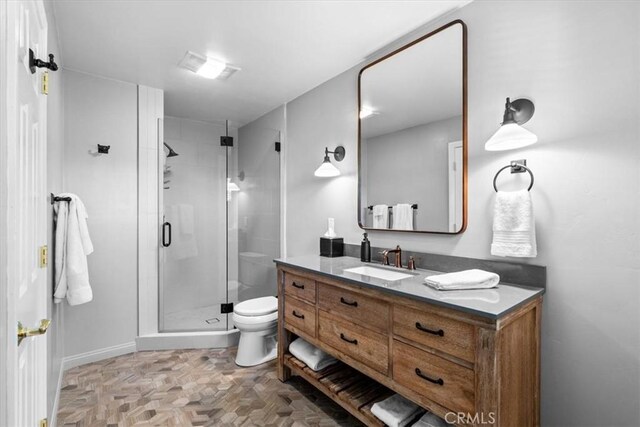 27833 Hamiltair Dr, Lake Arrowhead, CA 92352 - bathroom featuring vanity, toilet, a stall shower, and baseboards