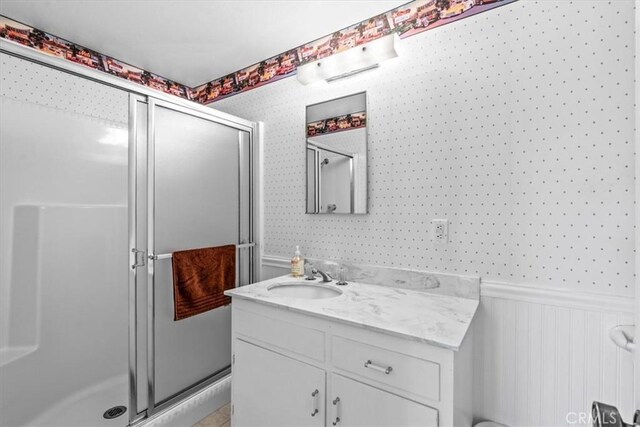 27833 Hamiltair Dr, Lake Arrowhead, CA 92352 - bathroom with vanity, a shower stall, and a wainscoted wall