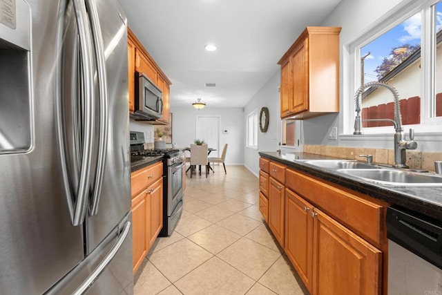 1409 Taft St, Escondido, CA 92026 - kitchen featuring stainless steel appliances, a sink, dark countertops, light tile patterned flooring, and recessed lighting