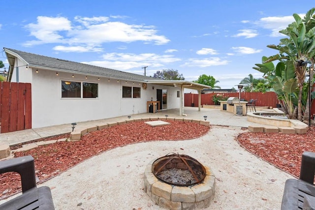 1409 Taft St, Escondido, CA 92026 - rear view of property with an outdoor fire pit, a fenced backyard, a patio area, stucco siding, and an outdoor kitchen
