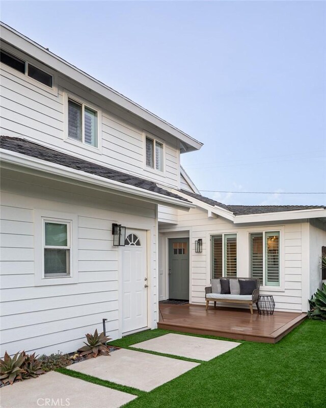 1792 Kenwood Pl, Costa Mesa, CA 92627 - back of property with a deck, a lawn, an outdoor hangout area, and a shingled roof