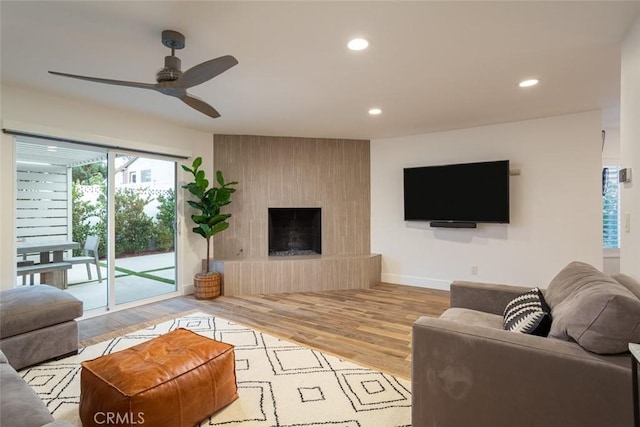1792 Kenwood Pl, Costa Mesa, CA 92627 - living room featuring recessed lighting, wood finished floors, a ceiling fan, and a large fireplace