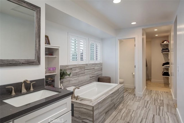 1792 Kenwood Pl, Costa Mesa, CA 92627 - bathroom with a bath, vanity, a walk in closet, and recessed lighting