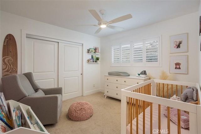 1792 Kenwood Pl, Costa Mesa, CA 92627 - bedroom with a crib, a closet, light colored carpet, and a ceiling fan