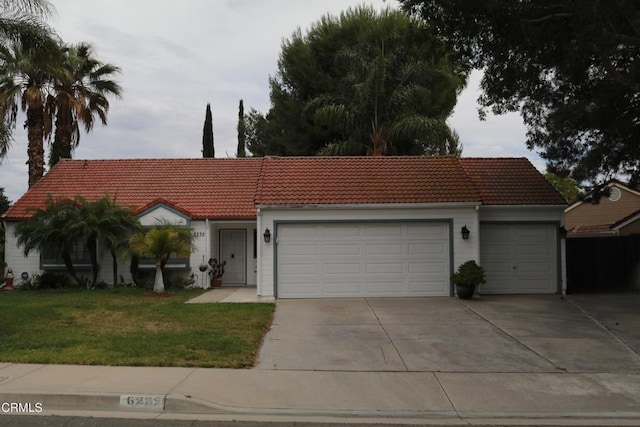 6232 Country View Ln, Riverside, CA 92504 - view of front facade featuring a tiled roof, a garage, driveway, and a front yard