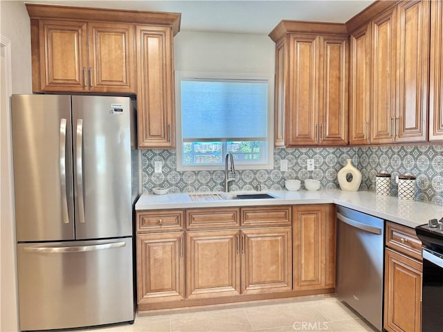 610 N Northwood Ave, Compton, CA 90220 - kitchen with stainless steel appliances, brown cabinets, light countertops, and tasteful backsplash