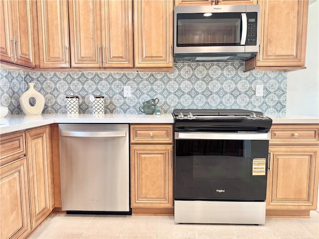 610 N Northwood Ave, Compton, CA 90220 - kitchen featuring stainless steel appliances, light countertops, and decorative backsplash