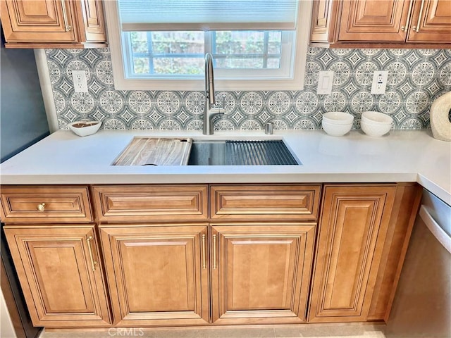 610 N Northwood Ave, Compton, CA 90220 - kitchen featuring light countertops, tasteful backsplash, and brown cabinets