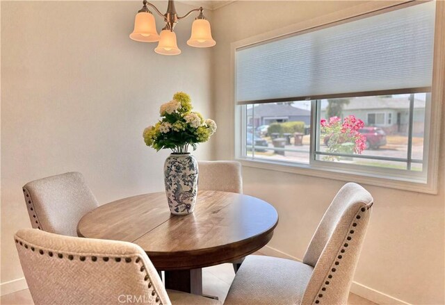 610 N Northwood Ave, Compton, CA 90220 - dining space with baseboards and a chandelier