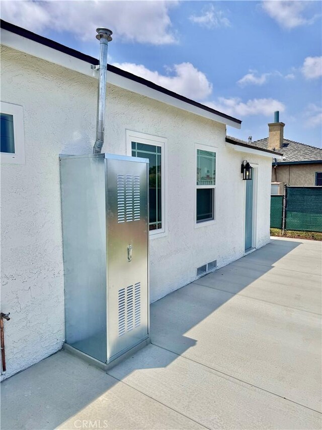 610 N Northwood Ave, Compton, CA 90220 - back of property with a patio, stucco siding, and a chimney