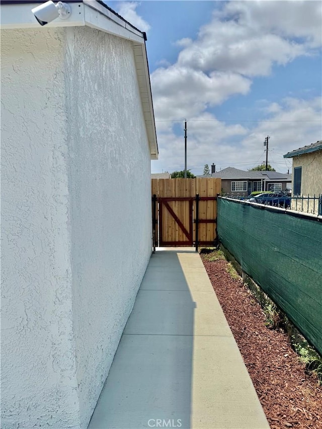 610 N Northwood Ave, Compton, CA 90220 - view of property exterior with stucco siding and a gate
