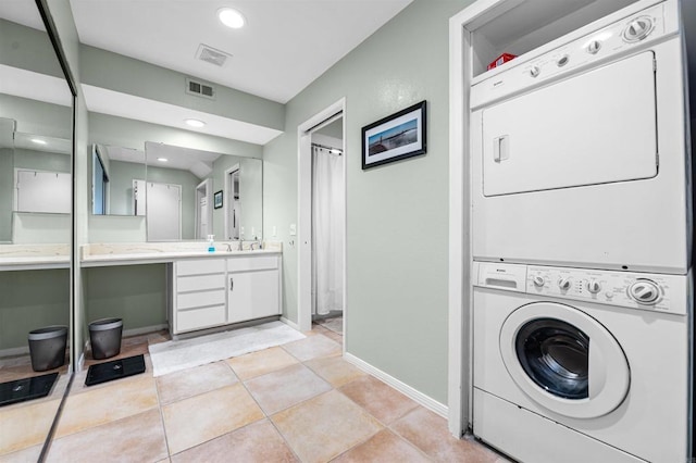 2537 Navarra Dr Unit 9B, Carlsbad, CA 92009 - laundry room with stacked washer / dryer, baseboards, light tile patterned floors, and recessed lighting