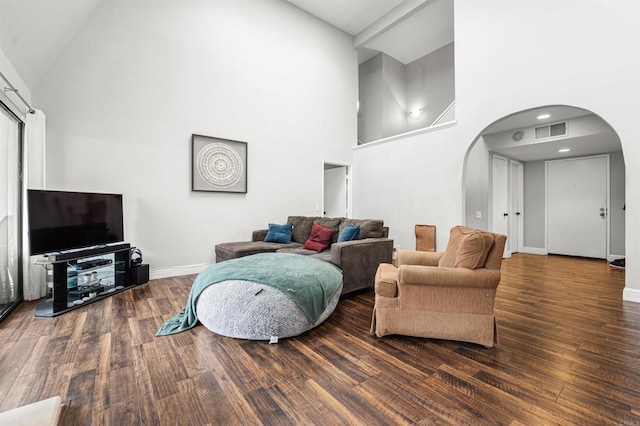 2537 Navarra Dr Unit 9B, Carlsbad, CA 92009 - living area with arched walkways, high vaulted ceiling, wood finished floors, and baseboards