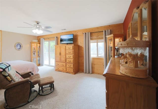21645 Jobs Peak Rd, Cedarpines Park, CA 92322 - bedroom featuring light colored carpet, wooden walls, access to outside, and ceiling fan