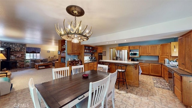 21645 Jobs Peak Rd, Cedarpines Park, CA 92322 - dining area featuring a chandelier, a wood stove, and light stone finish floors