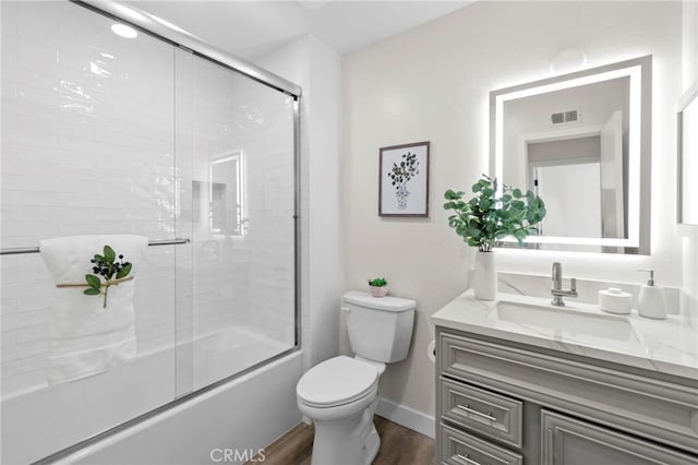 2900 S Greenville S Unit H, Santa Ana, CA 92704 - bathroom featuring wood finished floors, vanity, toilet, enclosed tub / shower combo, and baseboards