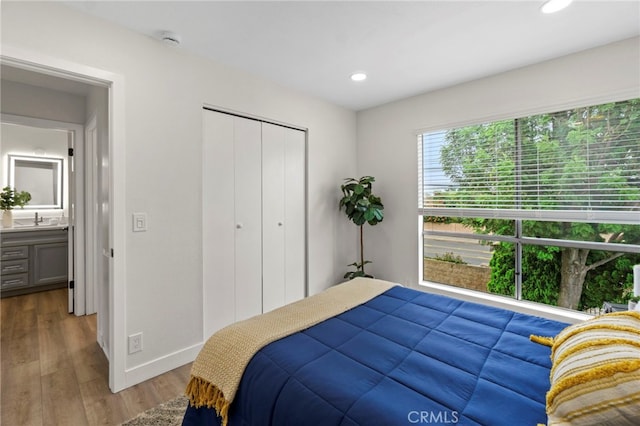 2900 S Greenville S Unit H, Santa Ana, CA 92704 - bedroom featuring baseboards, wood finished floors, recessed lighting, a closet, and a sink