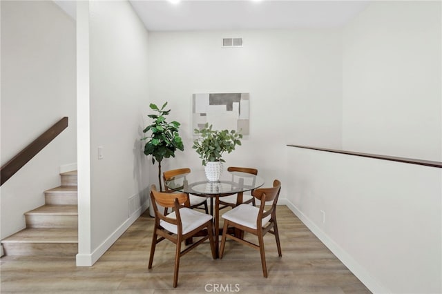 2900 S Greenville S Unit H, Santa Ana, CA 92704 - dining space featuring light wood-type flooring, baseboards, stairway, and recessed lighting