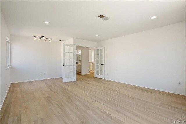29589 Hazel Glen Rd, Murrieta, CA 92563 - spare room featuring french doors, light wood-style floors, and recessed lighting