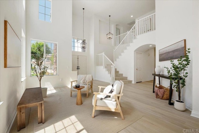 29589 Hazel Glen Rd, Murrieta, CA 92563 - foyer with a towering ceiling, stairway, arched walkways, and wood finished floors