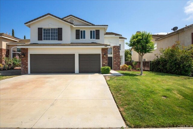 29589 Hazel Glen Rd, Murrieta, CA 92563 - traditional-style house featuring an attached garage, stucco siding, brick siding, and driveway