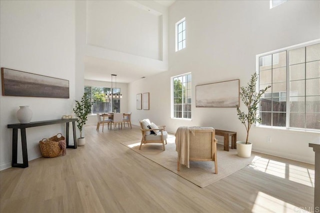 29589 Hazel Glen Rd, Murrieta, CA 92563 - living area featuring wood finished floors, a towering ceiling, and a chandelier