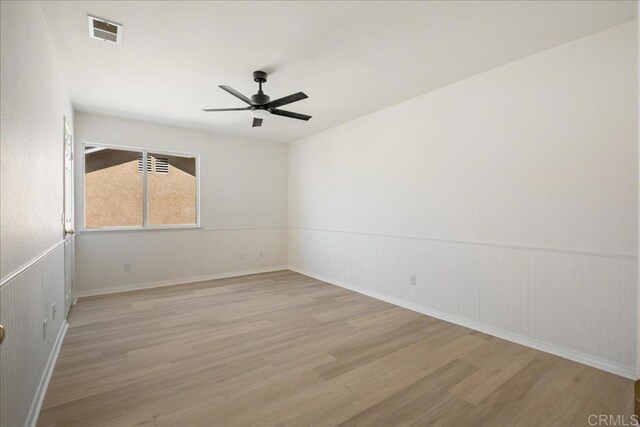 29589 Hazel Glen Rd, Murrieta, CA 92563 - spare room featuring wood finished floors, ceiling fan, and wainscoting