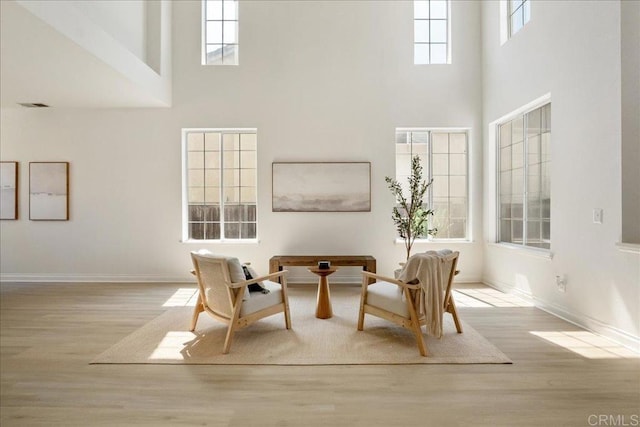 29589 Hazel Glen Rd, Murrieta, CA 92563 - sitting room featuring a high ceiling, wood finished floors, and plenty of natural light